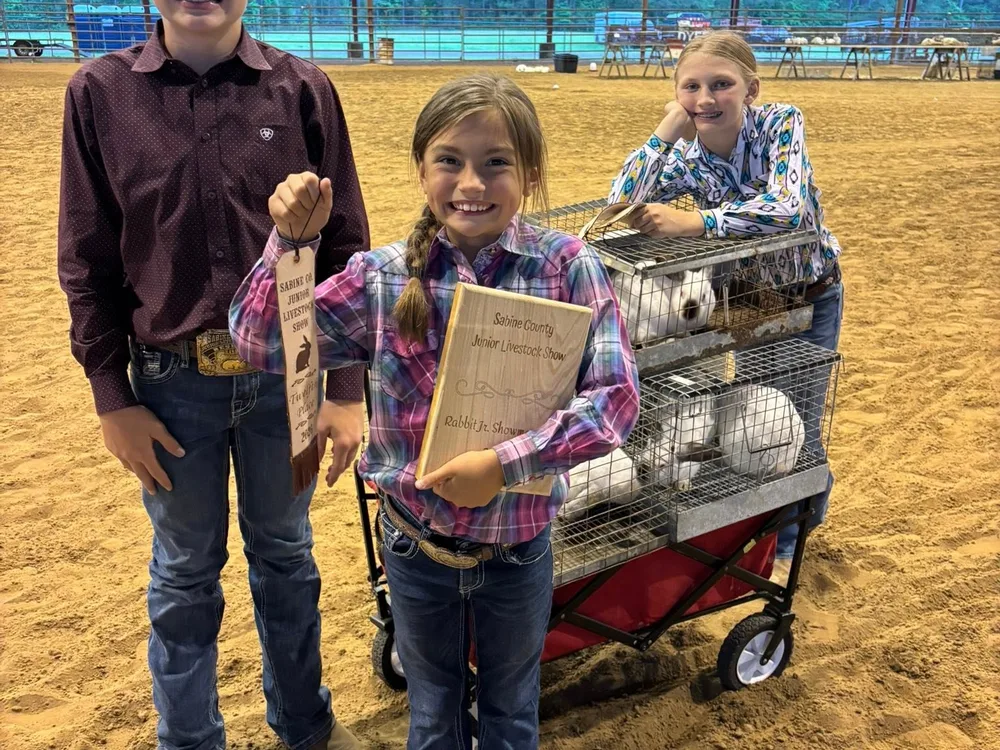 Three young exhibitors with a wagon and their entry papers on show day